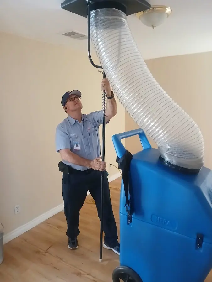 Furnace Tune-Up technician using HEPA equipment in California City